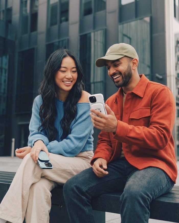 Two friends laughing over a phone