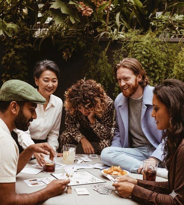 Friends trying drinks and snacks around a table